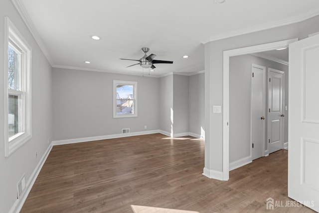 spare room with ornamental molding, recessed lighting, wood finished floors, and baseboards