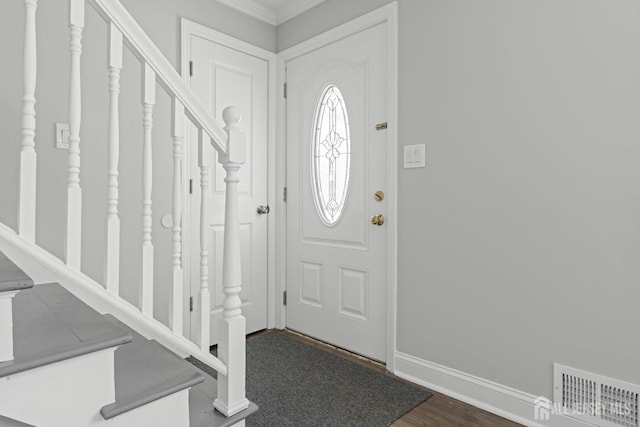 entryway with stairs, dark wood-style floors, visible vents, and baseboards