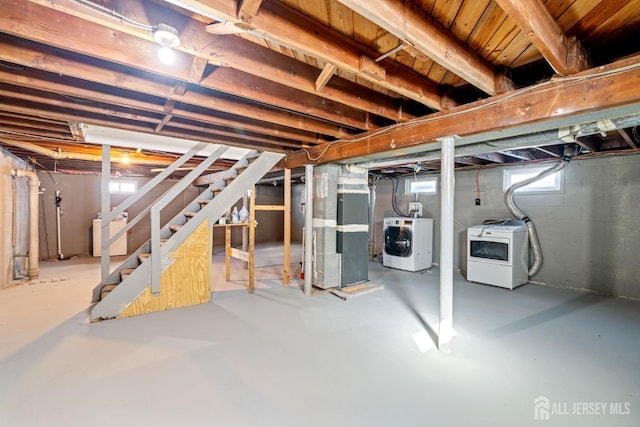 basement featuring separate washer and dryer and heating unit