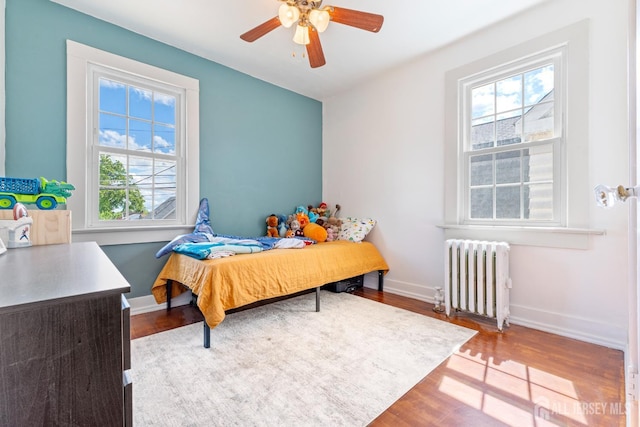 54 5th St, Fords, NJ 08863 - bedroom with radiator, multiple windows, wood finished floors, and baseboards