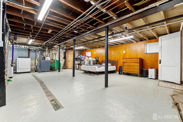 54 5th St, Fords, NJ 08863 - unfinished basement featuring washer / clothes dryer, a water pressure tank, wooden walls, and a heating unit