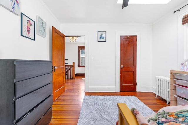 54 5th St, Fords, NJ 08863 - bedroom with radiator, wood finished floors, ornamental molding, baseboards, and ceiling fan