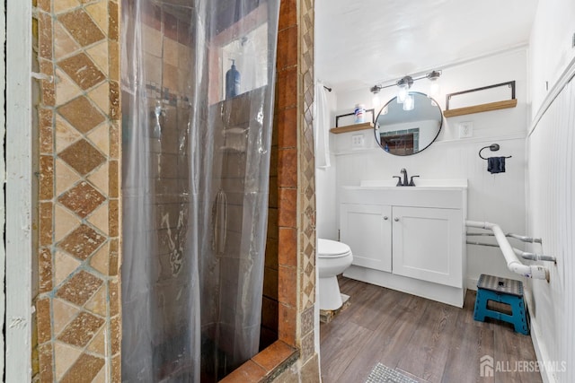54 5th St, Fords, NJ 08863 - full bath featuring vanity, a stall shower, wood finished floors, toilet, and a wainscoted wall