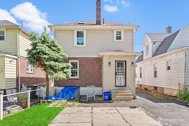 54 5th St, Fords, NJ 08863 - back of house with a chimney and brick siding
