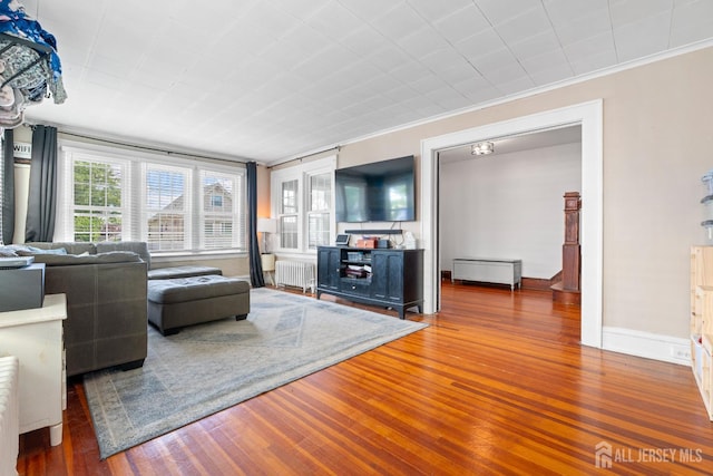 54 5th St, Fords, NJ 08863 - living area featuring radiator, wood finished floors, and crown molding