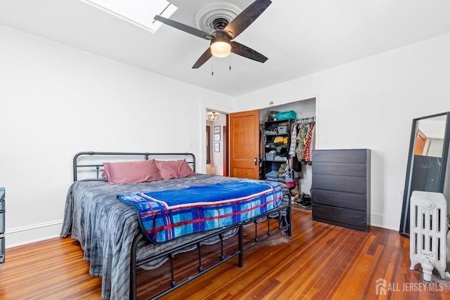 54 5th St, Fords, NJ 08863 - bedroom with wood finished floors, baseboards, radiator, and a closet