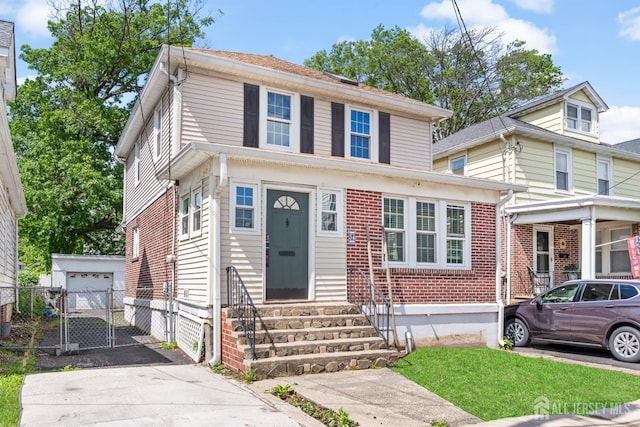 54 5th St, Fords, NJ 08863 - american foursquare style home featuring entry steps, brick siding, driveway, a gate, and an outdoor structure