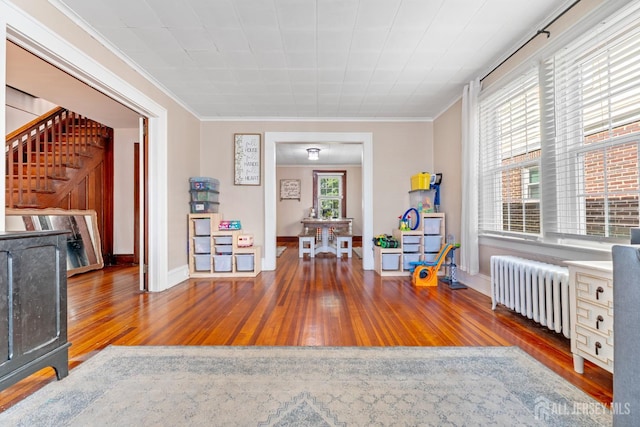 54 5th St, Fords, NJ 08863 - sitting room with radiator heating unit, hardwood / wood-style flooring, crown molding, and stairs