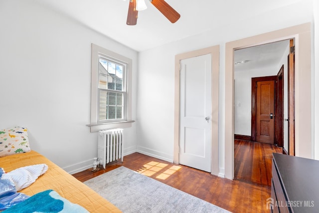 54 5th St, Fords, NJ 08863 - bedroom featuring radiator heating unit, wood finished floors, and ceiling fan