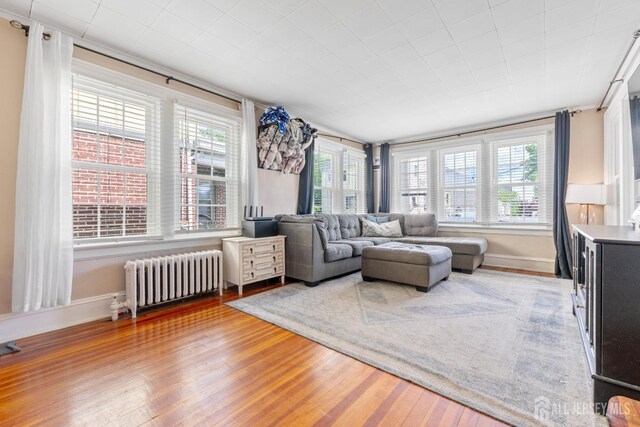 54 5th St, Fords, NJ 08863 - living area with radiator heating unit and wood finished floors