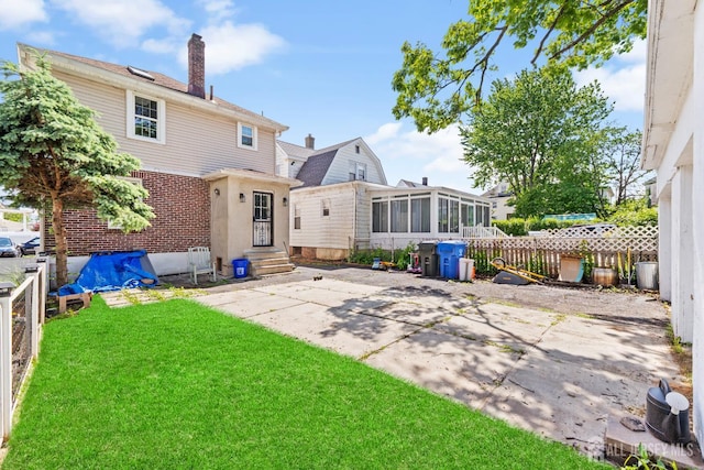 54 5th St, Fords, NJ 08863 - rear view of house with entry steps, a sunroom, a chimney, and a patio area