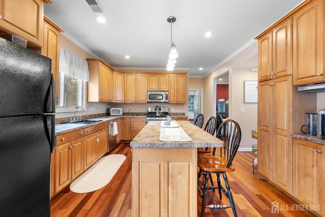 445 Grace Hill Rd, Monroe, NJ 08831 - kitchen featuring ornamental molding, appliances with stainless steel finishes, a sink, light wood finished floors, and a breakfast bar area