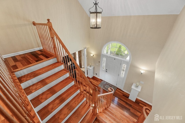 445 Grace Hill Rd, Monroe, NJ 08831 - foyer entrance with an inviting chandelier, wood finished floors, a high ceiling, stairs, and baseboards