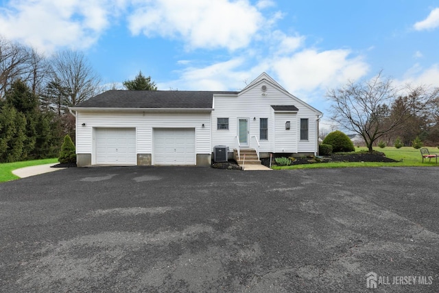 445 Grace Hill Rd, Monroe, NJ 08831 - view of front facade featuring a garage, roof with shingles, entry steps, driveway, and central AC unit