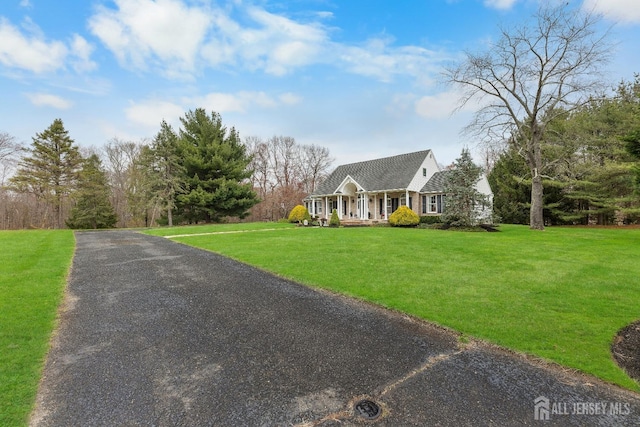 445 Grace Hill Rd, Monroe, NJ 08831 - cape cod-style house with a front yard and covered porch