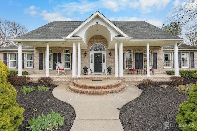445 Grace Hill Rd, Monroe, NJ 08831 - exterior space featuring a porch, a shingled roof, and brick siding