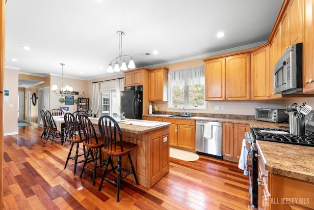 445 Grace Hill Rd, Monroe, NJ 08831 - kitchen with a kitchen breakfast bar, a kitchen island, a sink, stainless steel appliances, and a notable chandelier