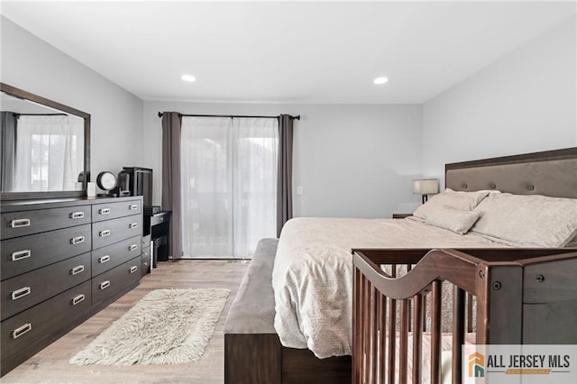 bedroom featuring access to exterior and light wood-type flooring