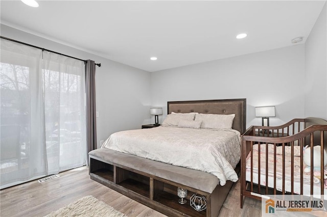 bedroom with access to outside and light wood-type flooring