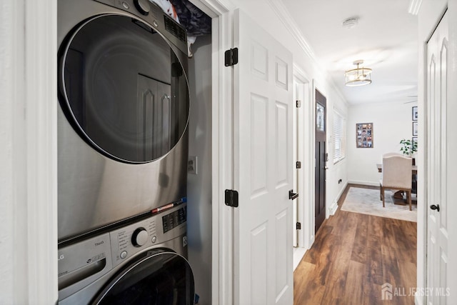 1 York St, Old Bridge, NJ 08857 - clothes washing area with stacked washing machine and dryer, dark wood finished floors, baseboards, ornamental molding, and a chandelier