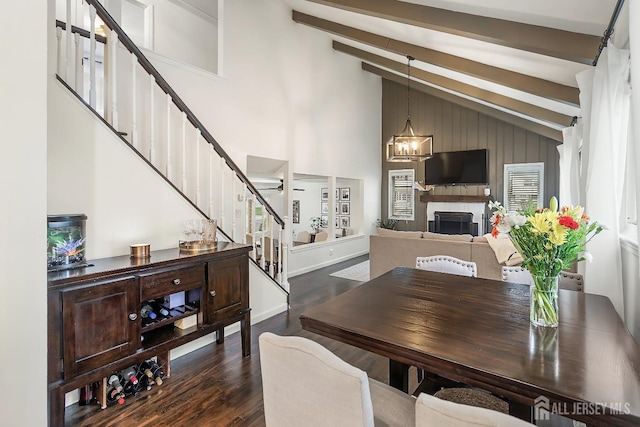 1 York St, Old Bridge, NJ 08857 - dining area featuring stairway, dark wood-style flooring, beamed ceiling, high vaulted ceiling, and a fireplace