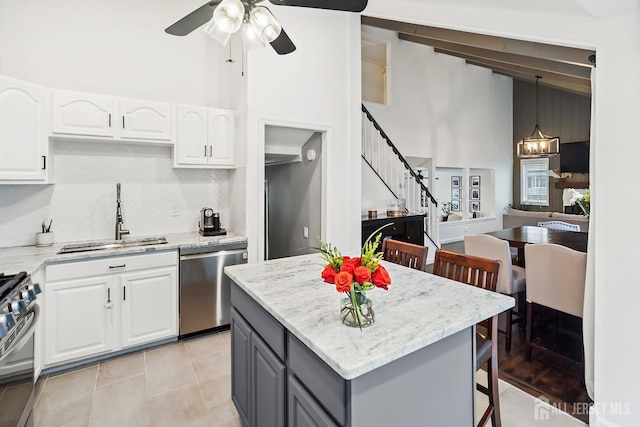 1 York St, Old Bridge, NJ 08857 - kitchen with appliances with stainless steel finishes, a sink, gray cabinetry, white cabinetry, and high vaulted ceiling