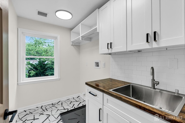 35 Glenville Rd, Edison, NJ 08817 - kitchen with tasteful backsplash, white cabinets, open shelves, and butcher block counters