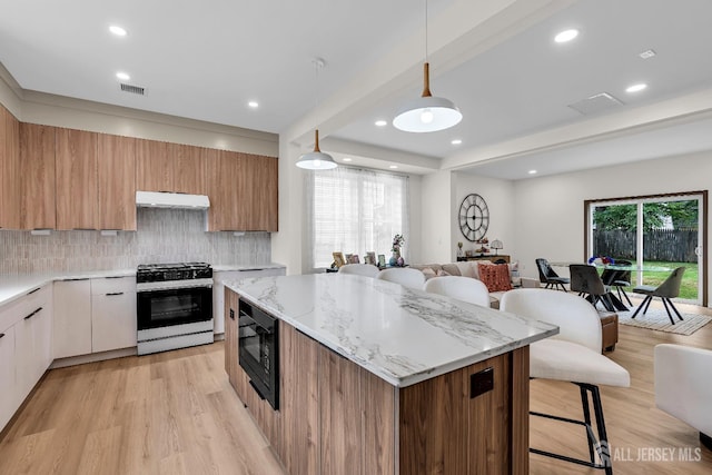 35 Glenville Rd, Edison, NJ 08817 - kitchen with gas stove, black microwave, a breakfast bar, modern cabinets, and open floor plan