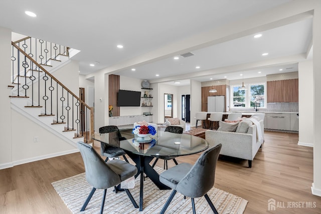 35 Glenville Rd, Edison, NJ 08817 - dining area with light wood finished floors, stairway, and recessed lighting
