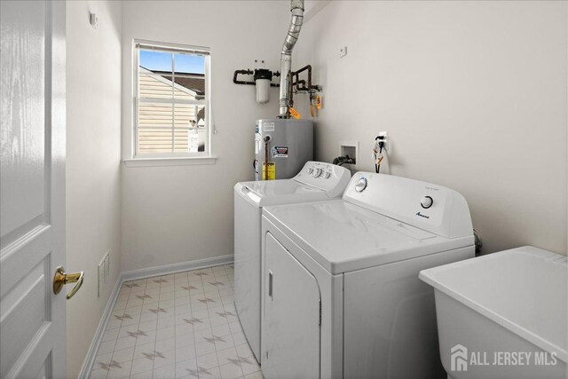 laundry area featuring independent washer and dryer, sink, and water heater