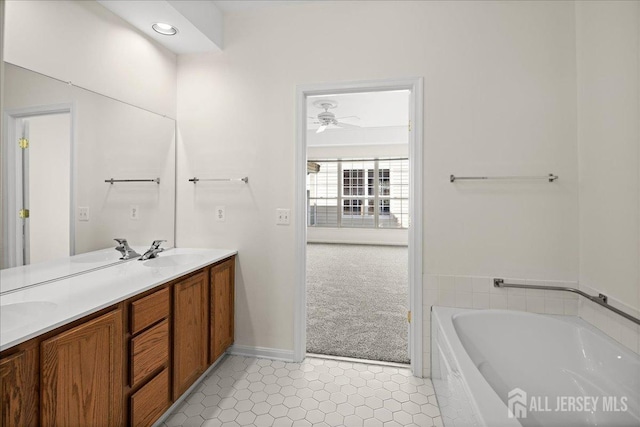 bathroom featuring tile patterned flooring, double vanity, a sink, and a bath