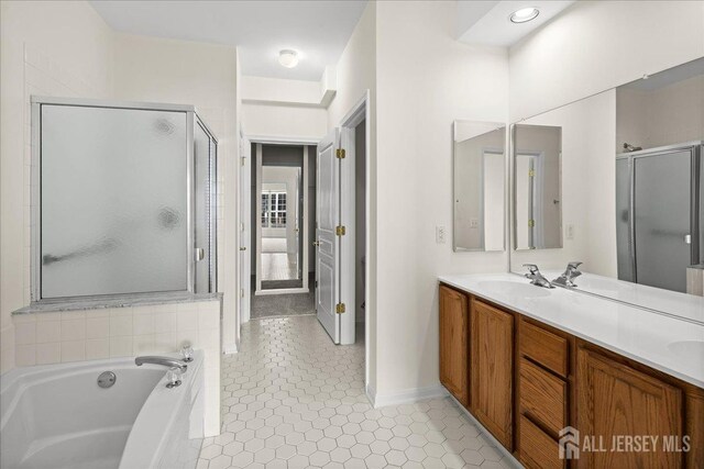 bathroom with vanity, tile patterned flooring, and shower with separate bathtub