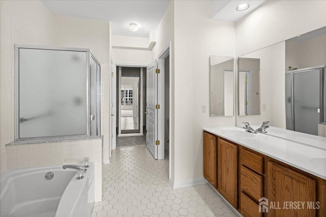 full bath with double vanity, a bath, tile patterned flooring, a shower stall, and a sink