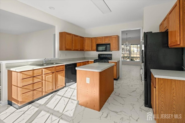 kitchen featuring a sink, marble finish floor, light countertops, a center island, and black appliances