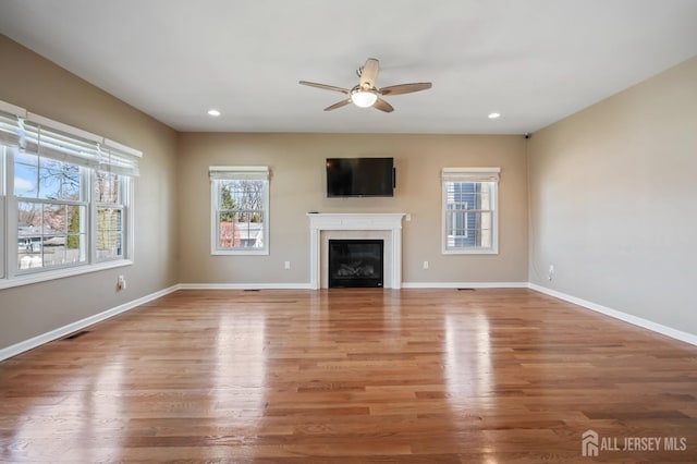 120 Normandy Rd, Colonia, NJ 07067 - unfurnished living room featuring a ceiling fan, light wood-style flooring, baseboards, a glass covered fireplace, and recessed lighting