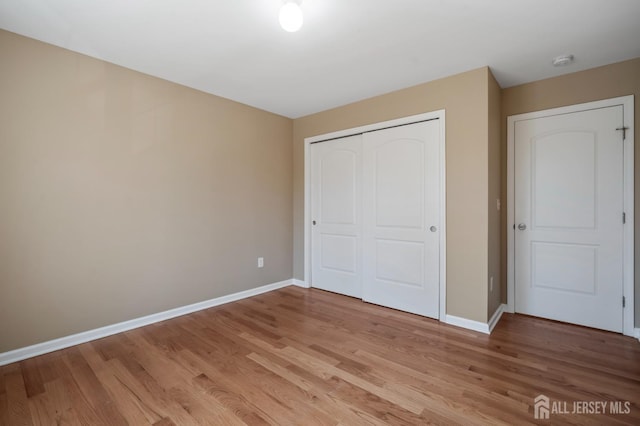 120 Normandy Rd, Colonia, NJ 07067 - unfurnished bedroom featuring baseboards, a closet, and light wood-style floors