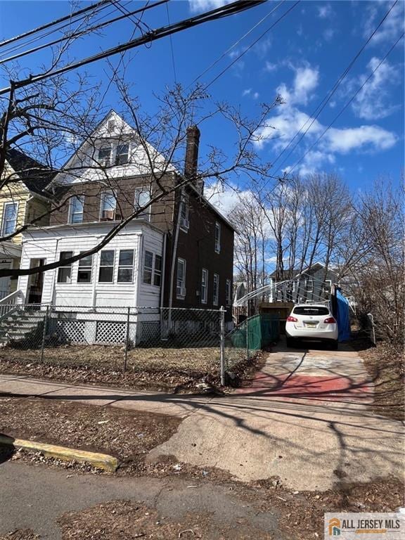 43 Senior St, New Brunswick, NJ 08901 - view of home's exterior with driveway and a fenced front yard