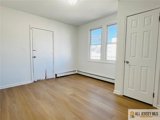 97 Ford Ave, Fords, NJ 08863 - spare room featuring baseboards, light wood-type flooring, and a baseboard radiator