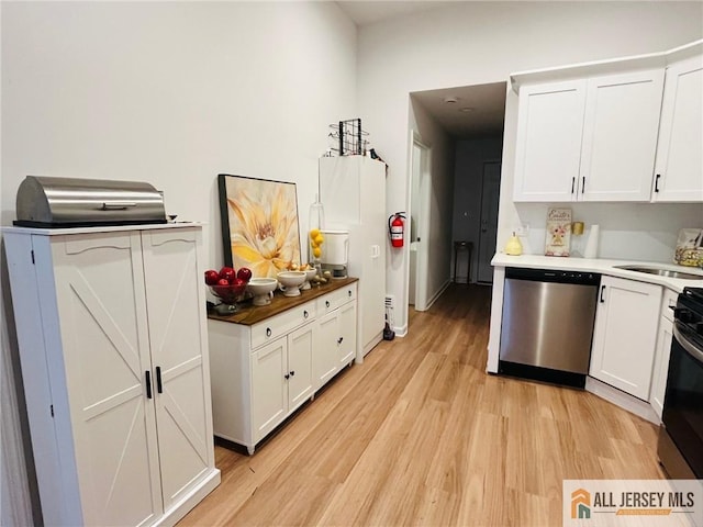 97 Ford Ave, Fords, NJ 08863 - kitchen featuring light wood-type flooring, a sink, stainless steel dishwasher, white cabinets, and stove