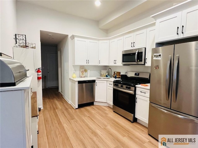 97 Ford Ave, Fords, NJ 08863 - kitchen with a sink, light countertops, light wood-style flooring, and stainless steel appliances