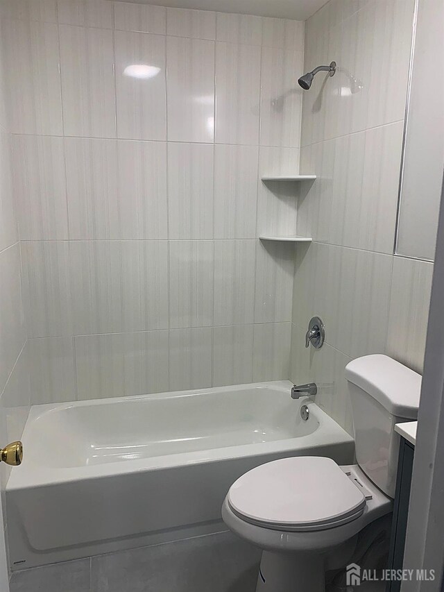 full bathroom featuring shower / bath combination, toilet, tile walls, and vanity