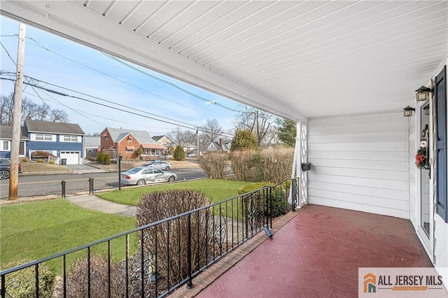 balcony featuring a porch and a lawn