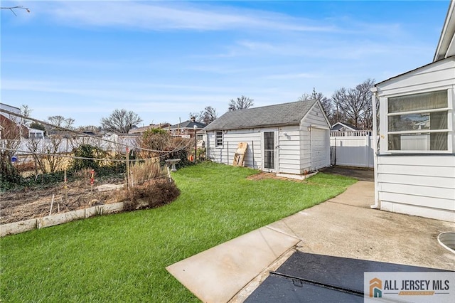 view of yard featuring a patio and an outbuilding