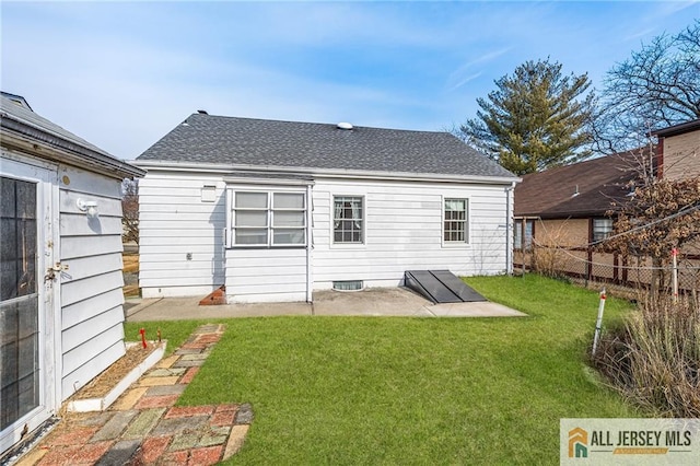 rear view of property featuring a patio and a lawn