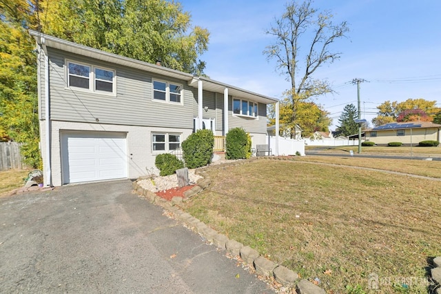 bi-level home featuring a front yard and a garage