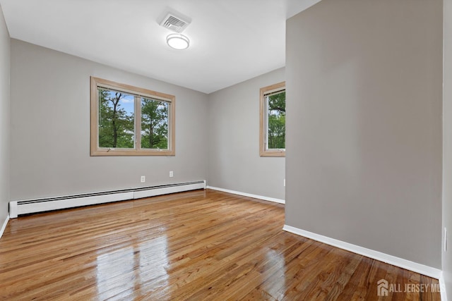 40 Montclair Ave, Edison, NJ 08820 - spare room with a baseboard heating unit, wood finished floors, and baseboards