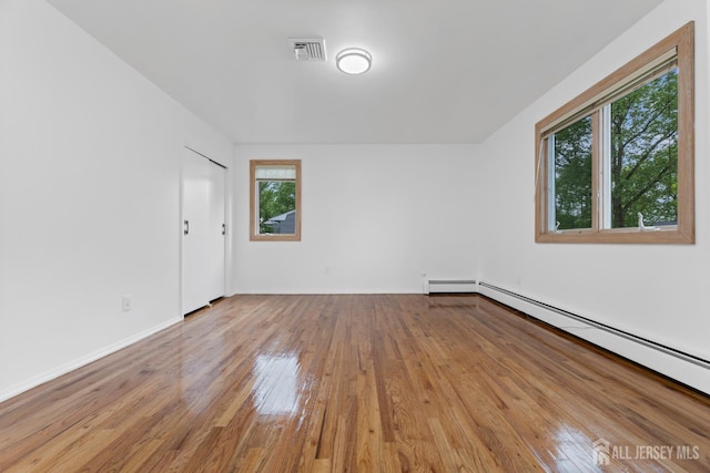 40 Montclair Ave, Edison, NJ 08820 - empty room with a baseboard heating unit and hardwood / wood-style floors