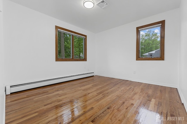 40 Montclair Ave, Edison, NJ 08820 - spare room featuring a baseboard radiator, healthy amount of natural light, wood finished floors, and baseboards