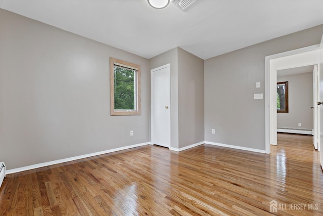 40 Montclair Ave, Edison, NJ 08820 - unfurnished room with baseboard heating, wood finished floors, and baseboards