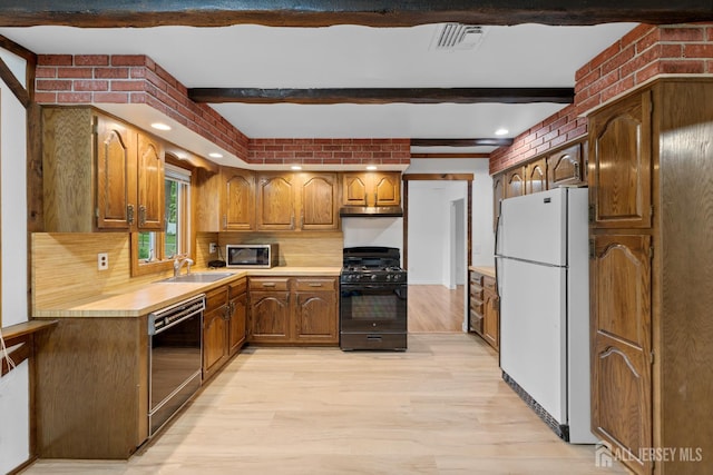 40 Montclair Ave, Edison, NJ 08820 - kitchen with black appliances, a sink, beam ceiling, light countertops, and light wood-style floors